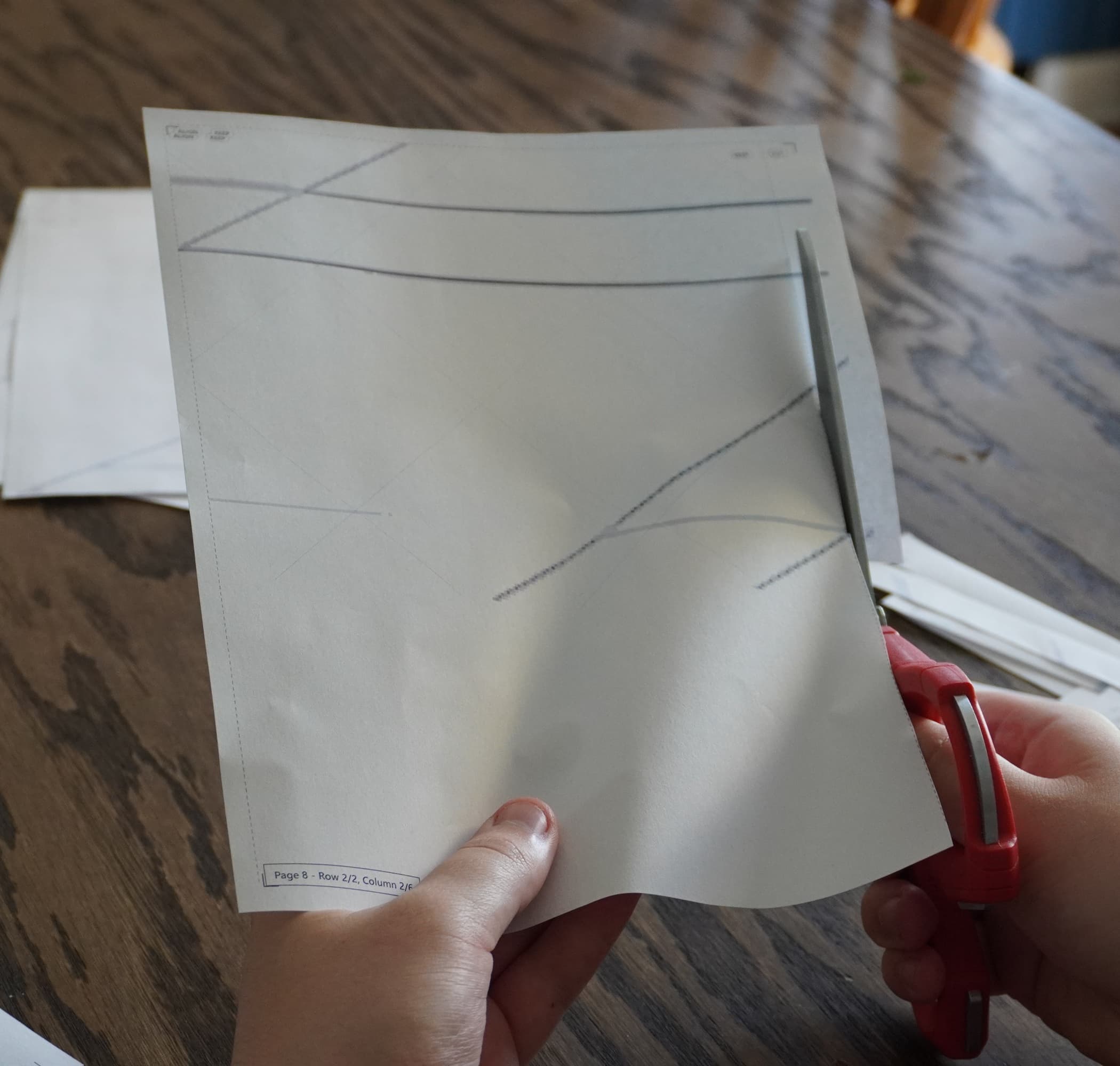 Printed paper template being cut with scissors